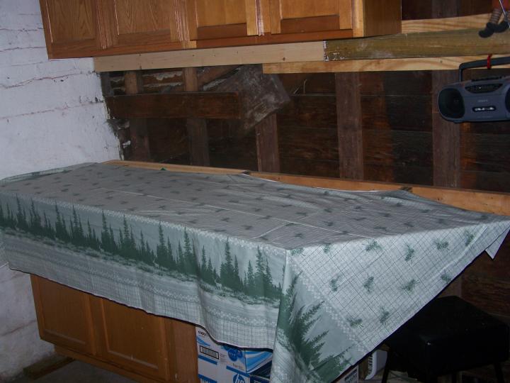 &quot;measuring&quot; the right amount of fabric to cover the particle board serving as a &quot;counter&quot;